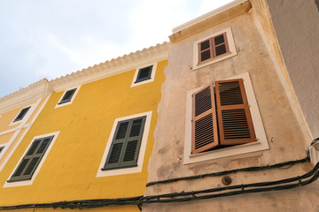 Fototapeta na wymiar Windows shutters on buildings in old town Ciutadella, Menorca.
