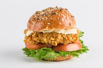 Classic Burger with chicken in a bun with sesame tomatoes, lettuce and mustard sauce.