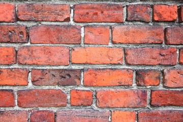Grunge red brick wall with textured blocks, selective focus. Old stone wall. Red bricks background. Construction works.  Brickwork. 