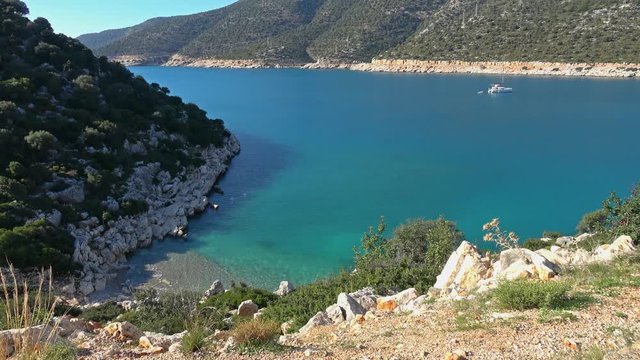 Gokliman beach, Finike, Turkey - 10th of January 2020: 4K Beautiful azure Gokliman bay and a boat