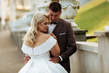 Full length body portrait of young bride and groom running on green grass of golf course, back view. Happy wedding couple walking through golf course, copy space