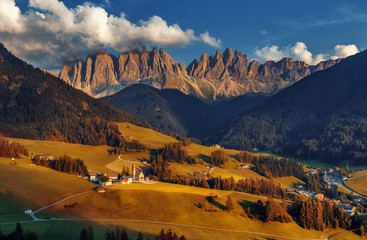 Wonderful Sunny Landscape of Dolomite Alps. Beautiful view of Santa Maddalena village at sunset in front of the Geisler or Odle Dolomites Group, autumn sunset in the Dolomites, Val di Funes, Italy.