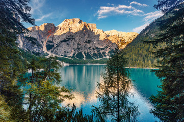 Incredible view on majestic famouse lake Braies during sunrise. Wonderful sunny landscape in dolomites Alps with perfect sky. Amazing nature Scenery. Lake Braies is also known as Lago di Braies