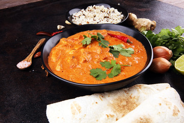 Chicken tikka masala spicy curry meat food in pot with rice and naan bread. indian food