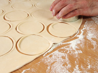 Cutting Dough into circles. Preparation Meat Dumplings.