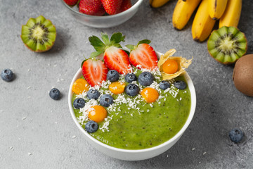 Green detox smoothie made from organic fruit and berries. Healthy lifestyle, diet and nutrition concept. 