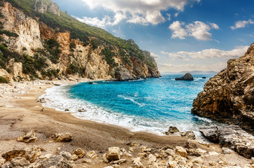 Fototapeta na wymiar Beautiful view over the sea beach in Kerkyra island. Wonderful morning seascape of Ionian Sea, Corfu island. Bright summer view of Gyali Beach. Greece, Europe. Awesome nature landscape.