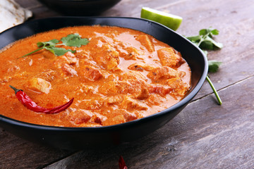 Chicken tikka masala spicy curry meat food in pot with rice and naan bread. indian food