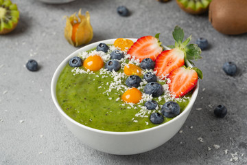 Green detox smoothie made from organic fruit and berries. Healthy lifestyle, diet and nutrition concept. 