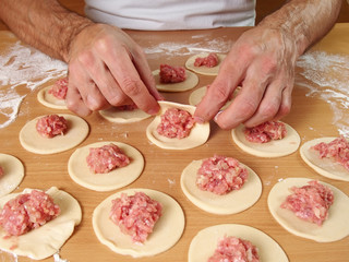 Fold Dough in half. Preparation Meat Dumplings.