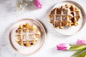 Belgian waffles with blueberries and icing sugar