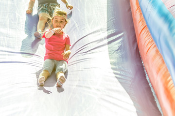 Little Girl sliding down an inflatable Slide