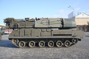 Close up of green armoured caterpillar transport. Modern military transportation vehicle...