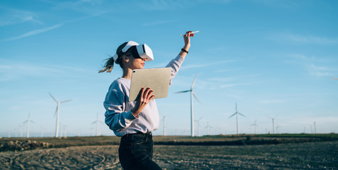 Woman creating virtual reality in open space