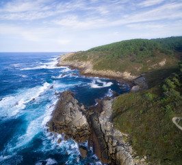 Coastline with strong waves hitting the coast. In the image we can see the shore with blue strong waves.