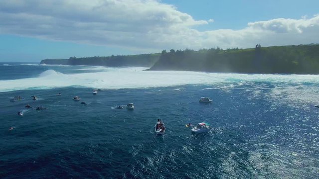 Surf competition on Hawaiian coastline, surfers and life saving beach lifeguard with inflatable rescue boats on dangerous ocean