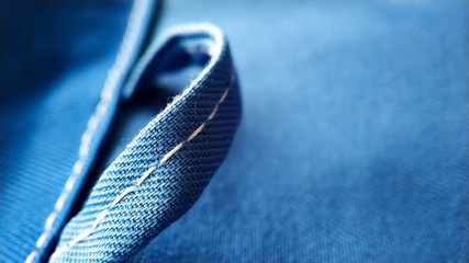 Loop on blue work clothes. workwear close-up macro seam, screed, texture
