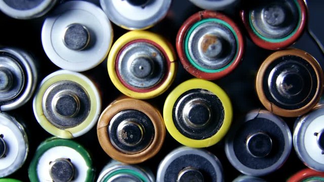 Lot of used batteries from different manufacturers. Electronic waste, collection and recycling, high danger for environment concept