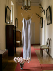  light white dress on a vintage hanger in the interiors of the 18th century