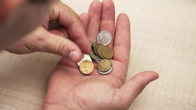 Close-up. boy counting money, coins in hand. Detail metal. Finance. Economic crisis.