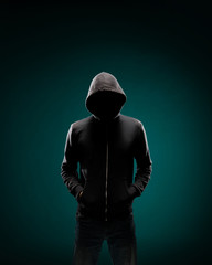 Computer hacker in hoodie. Obscured dark face. Data thief, internet fraud, darknet and cyber...
