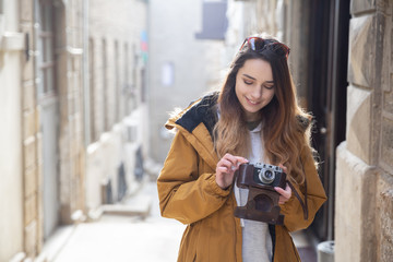 Photo of young tourist girl exploring streets of Baku. Moody photos of teenager girl visiting old city and taking photos of the city