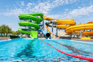 Outdoor water park. Multi-colored slides and pools.