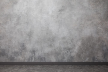 Interior with the gradient painted wall. spotty surface with copy space. Light gray wall with abstract spots and stripes.