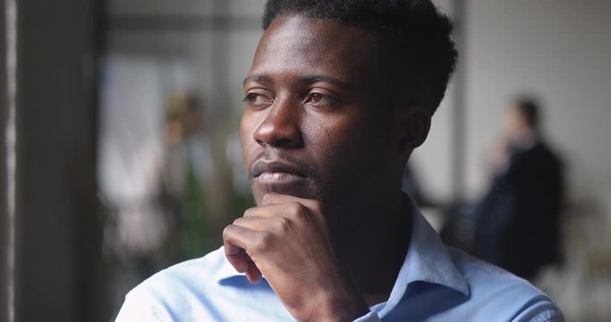 Thoughtful serious african businessman looking away thinking of future