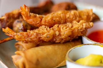 Dutch snacks for beer or wine, tempura shrimps, skewered chicken, bitterballs and hot dip sauces