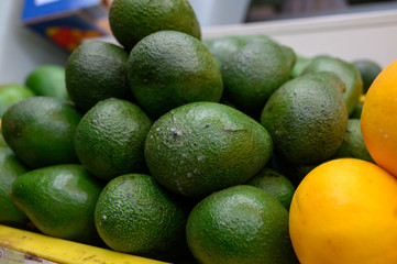 Fresh ripe green avocados in box on farmers market in Spain