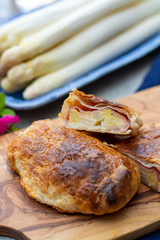 Pastry with bacon and white asparagus vegetables ready to eat served in spring garden