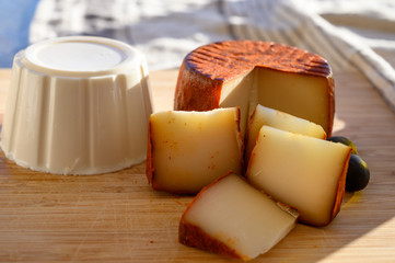 Cheese collection, piece of Spanish manchego cheese made from cow milk with red paprika and soft white cheese