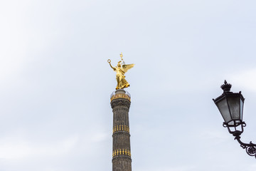 Fototapeta na wymiar Walk through the Tiergarten park in Berlin, the Victory Column and beautiful street lamps, Germany