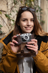 Photo of young tourist girl exploring streets of Baku. Moody photos of teenager girl visiting old city and taking photos of the city