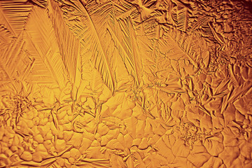 golden ice background, abstract yellow background, cold seasonal unusual ice, holiday texture