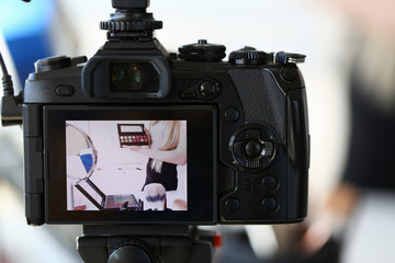 Female Blogger Advertise Makeup Beauty Product. Blond Woman Recording Video Blog. Vlogger Holding...
