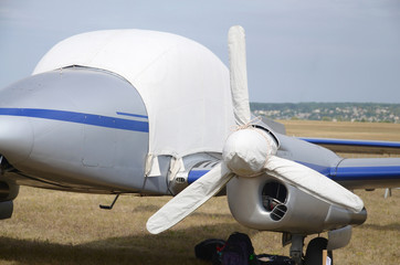 Fabric cover protects glass and propeller of the aircraft from sunlight and adverse weather...