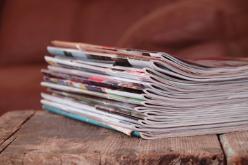 Old magazines on wooden table	