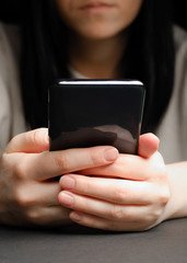Close-up of a woman using mobile smart phone. Smartphone in female hands