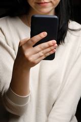 Close-up of a woman using mobile smart phone. Smartphone in female hands