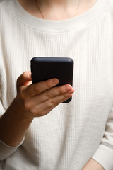 Close-up of a woman using mobile smart phone. Smartphone in female hands