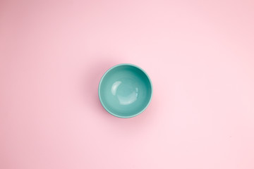  empty blue bowl on pink background