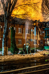 Firefighters extinguish a burning house with a fire-pump in the dark, Burning building in Samara, Russia, selective focus