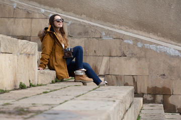 Photo of young tourist girl exploring streets of Baku. Moody photos of teenager girl visiting old city and taking photos of the city