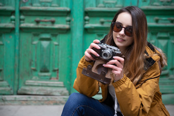 Photo of young tourist girl exploring streets of Baku. Moody photos of teenager girl visiting old city and taking photos of the city