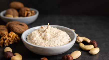 Homemade organic vegan butter made from almonds on a white background.