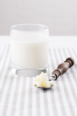 Homemade fermented beverage kefir with kefir grains in bowl on a white background, concept of natural fermented food and intestinal health
