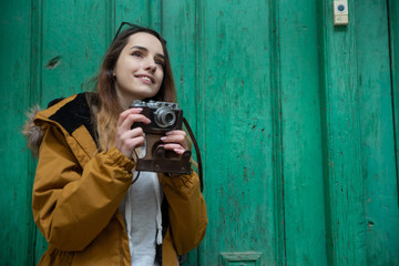 Photo of young tourist girl exploring streets of Baku. Moody photos of teenager girl visiting old city and taking photos of the city