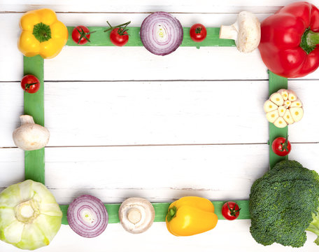 Multicolored vegetables on a white table. Top view. Free space for your text or recipe